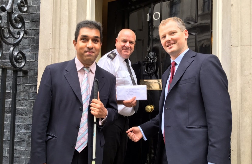 Pardeep Gill and Neil O’Brien MP handing in the petition to downing Street 